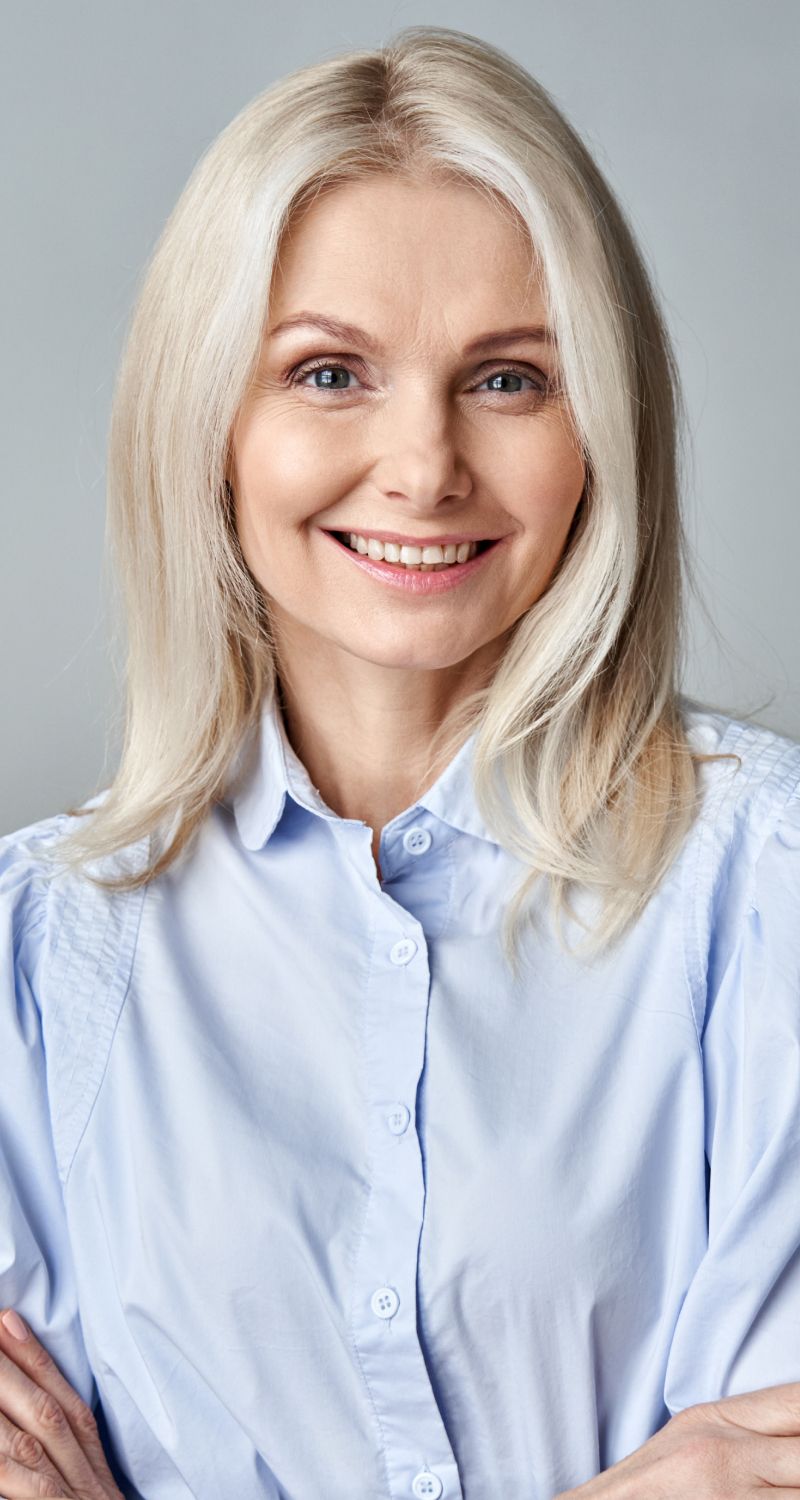 Smiling woman with long, light blonde hair.
