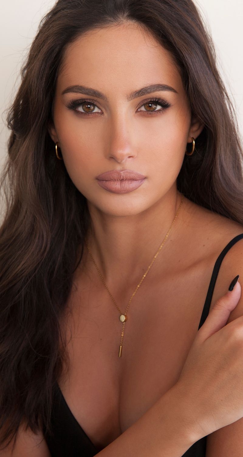 Woman with long hair and natural makeup.