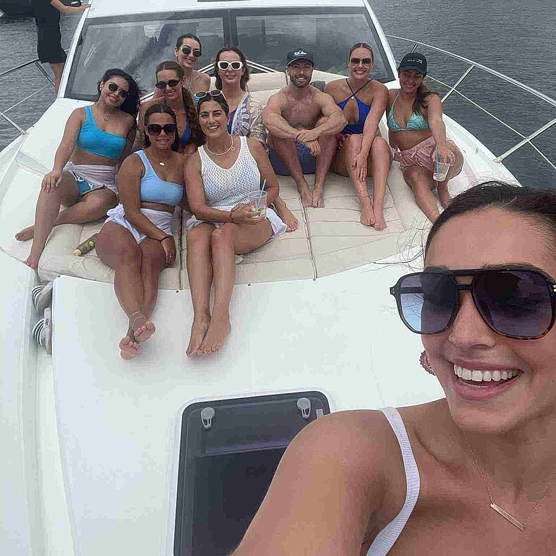 Group of friends enjoying a day on a yacht.