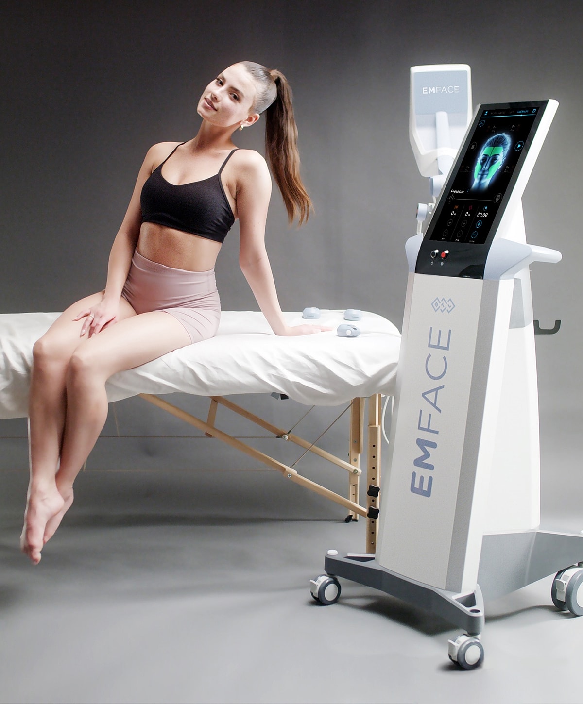 patient model beside EMFACE cosmetic treatment machine.