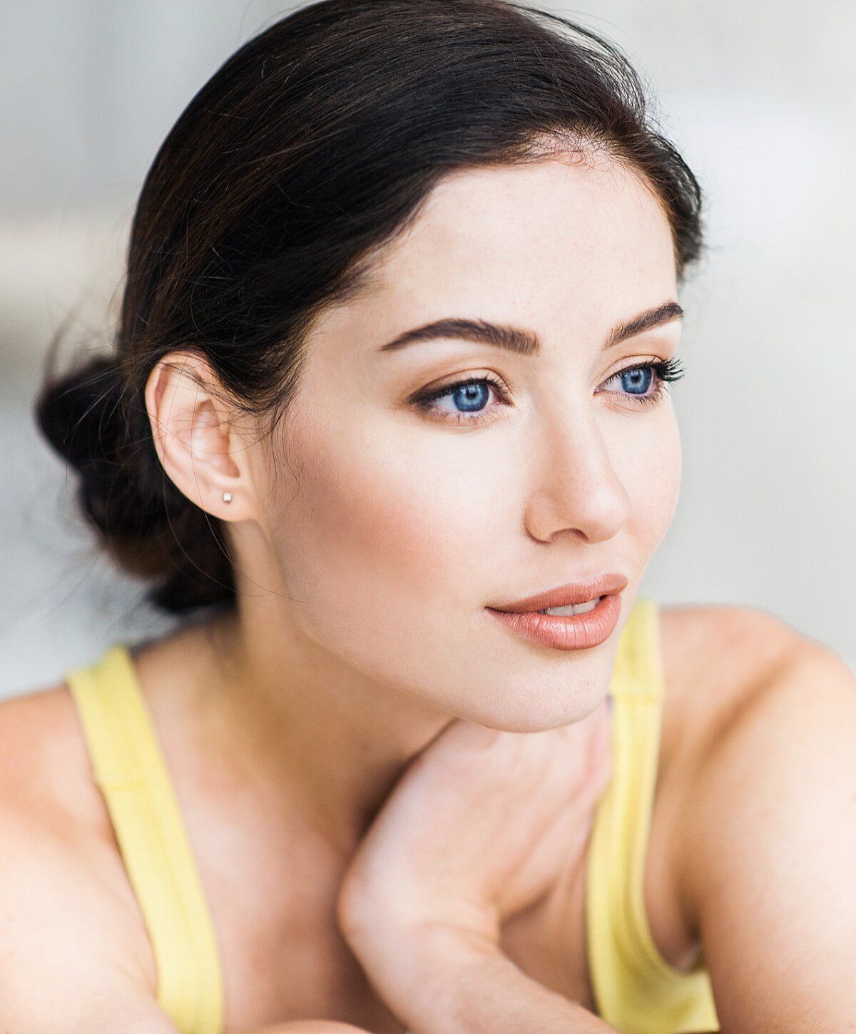 thread lift patient model with blue eyes and natural makeup.