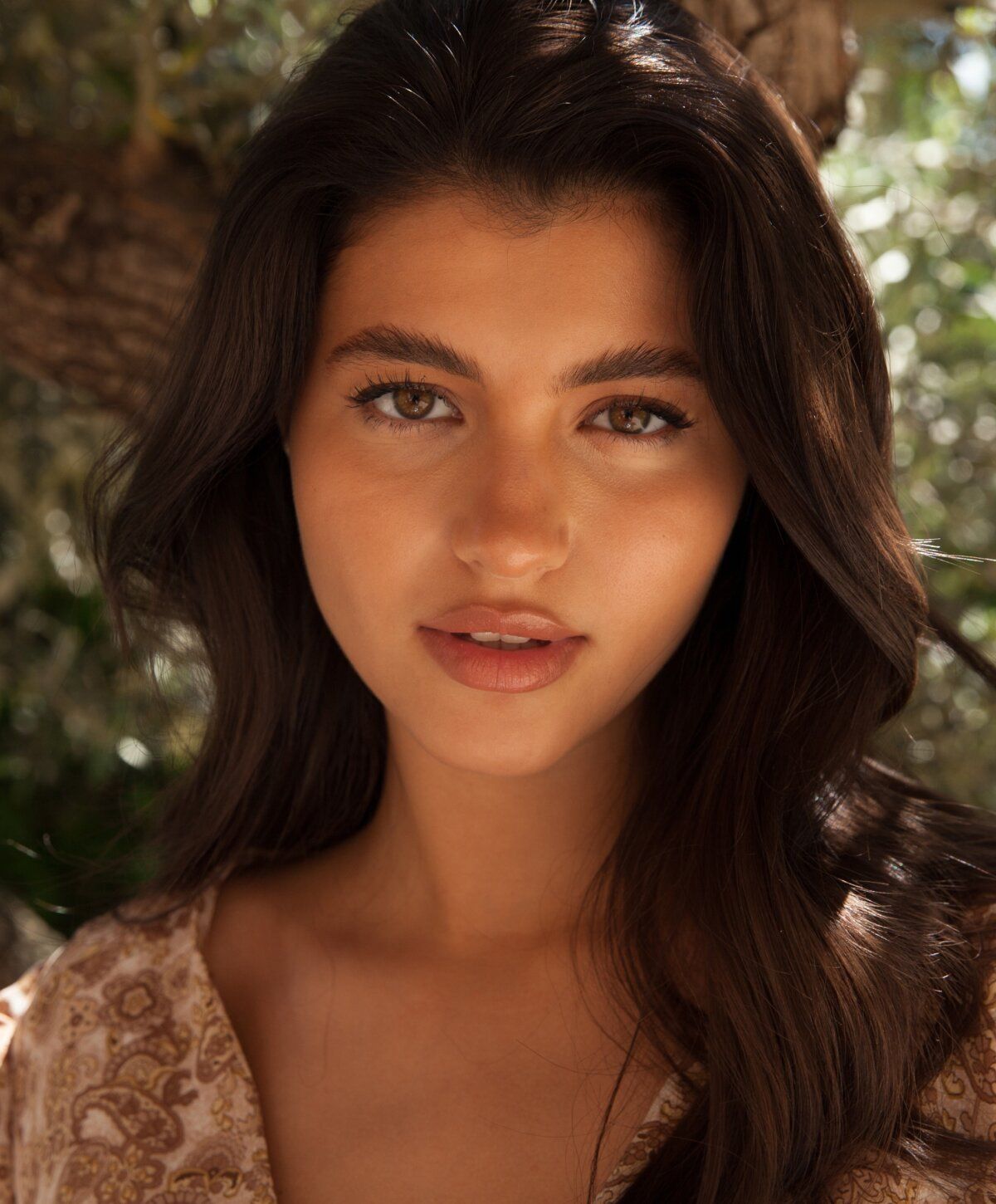 hair restoration with growth factors patient model with long dark hair and natural makeup.