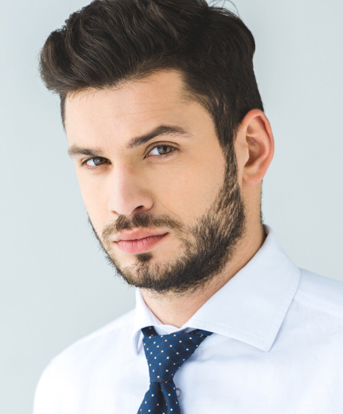 Male hair restoration with growth factors patient modelt in formal attire with beard.
