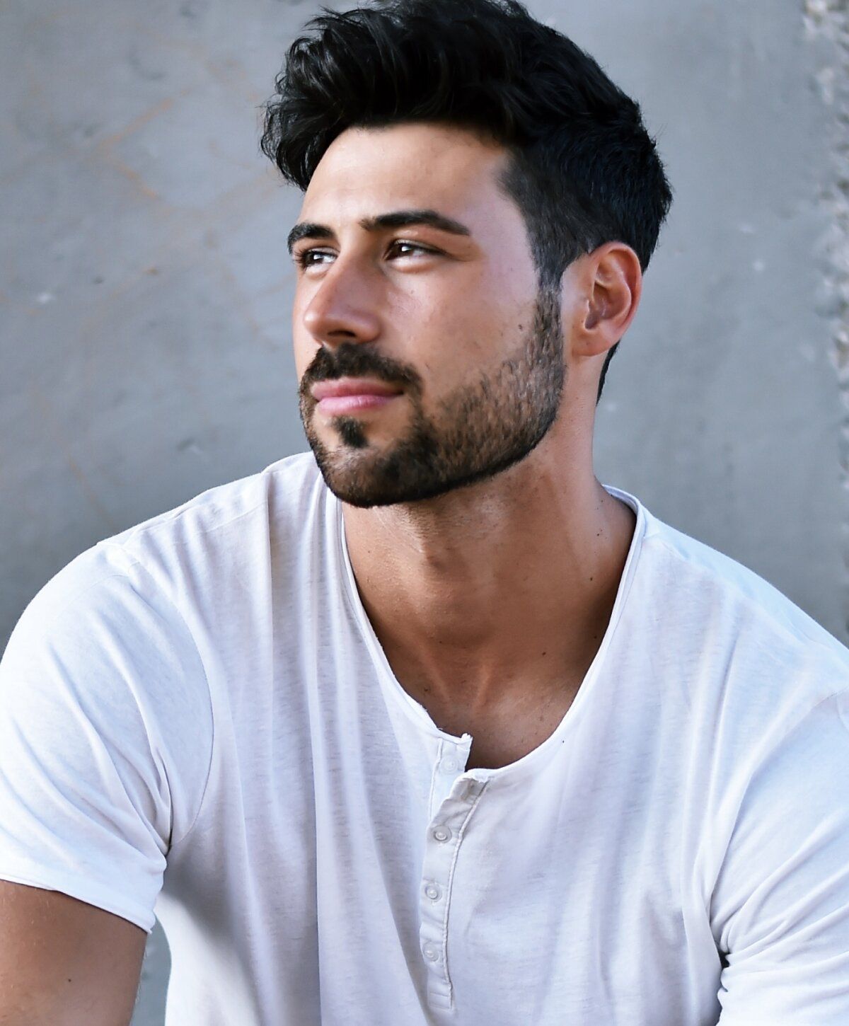 p shot patient model in a white shirt against a textured background.