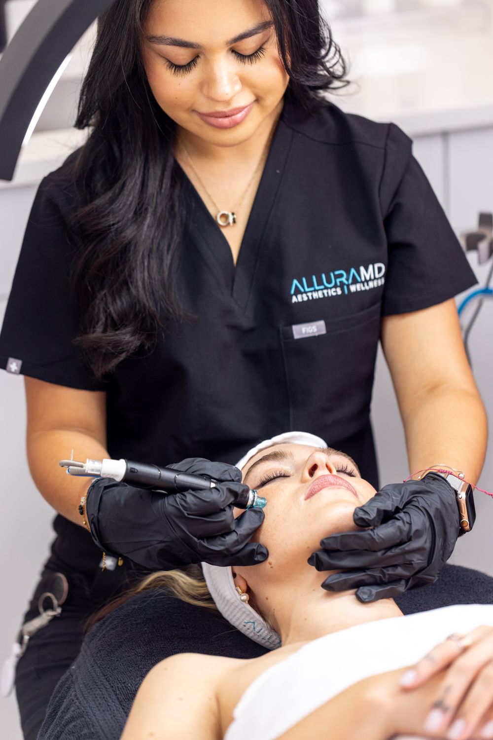 Esthetician performing hydrafacial on a patient model