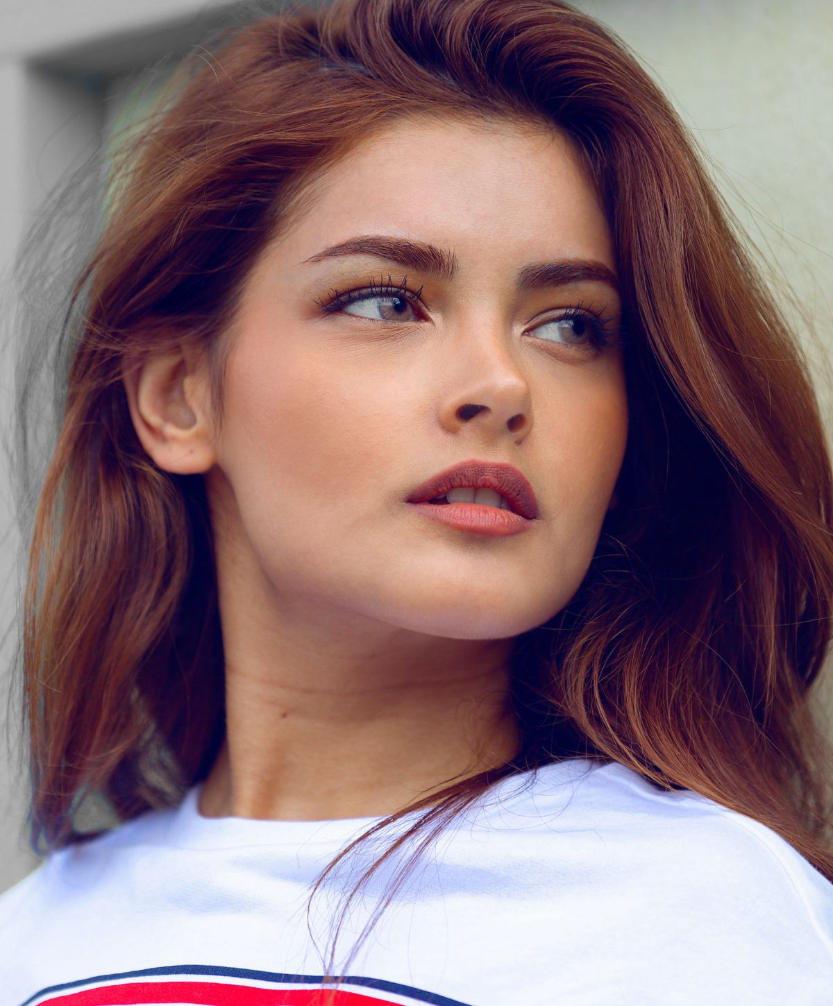 kybella patient model with flowing brown hair.