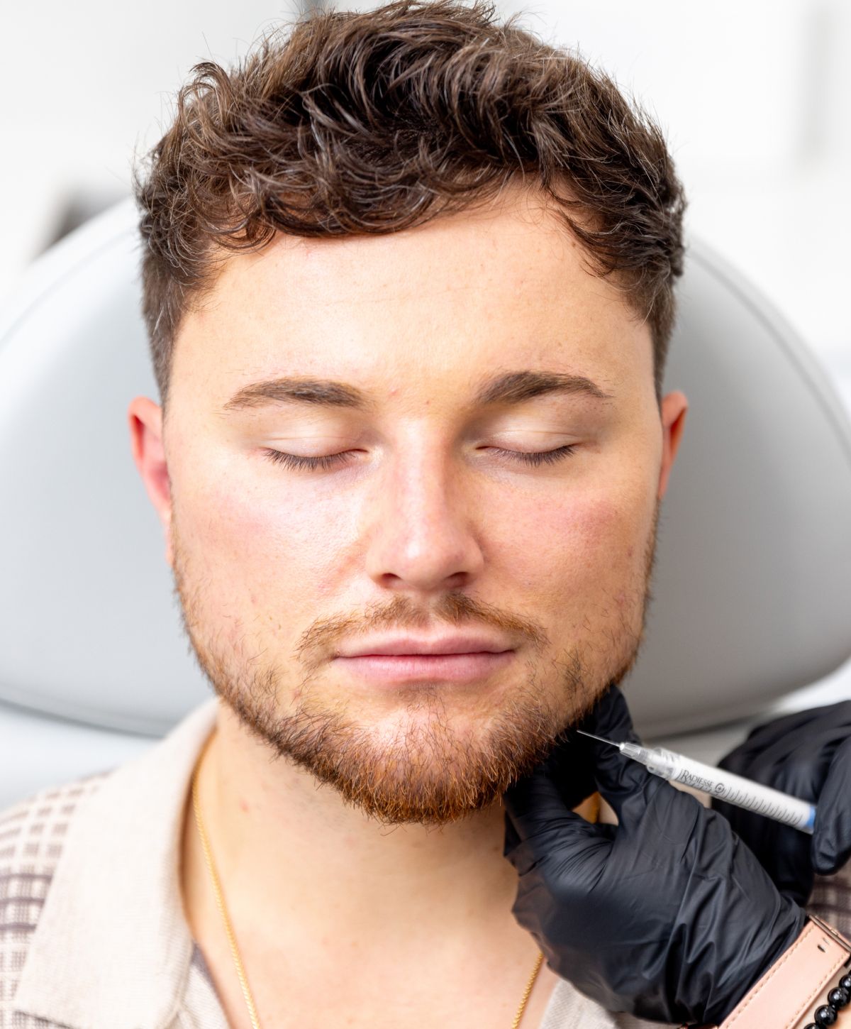 dysport patient model receiving an injection in his jaw