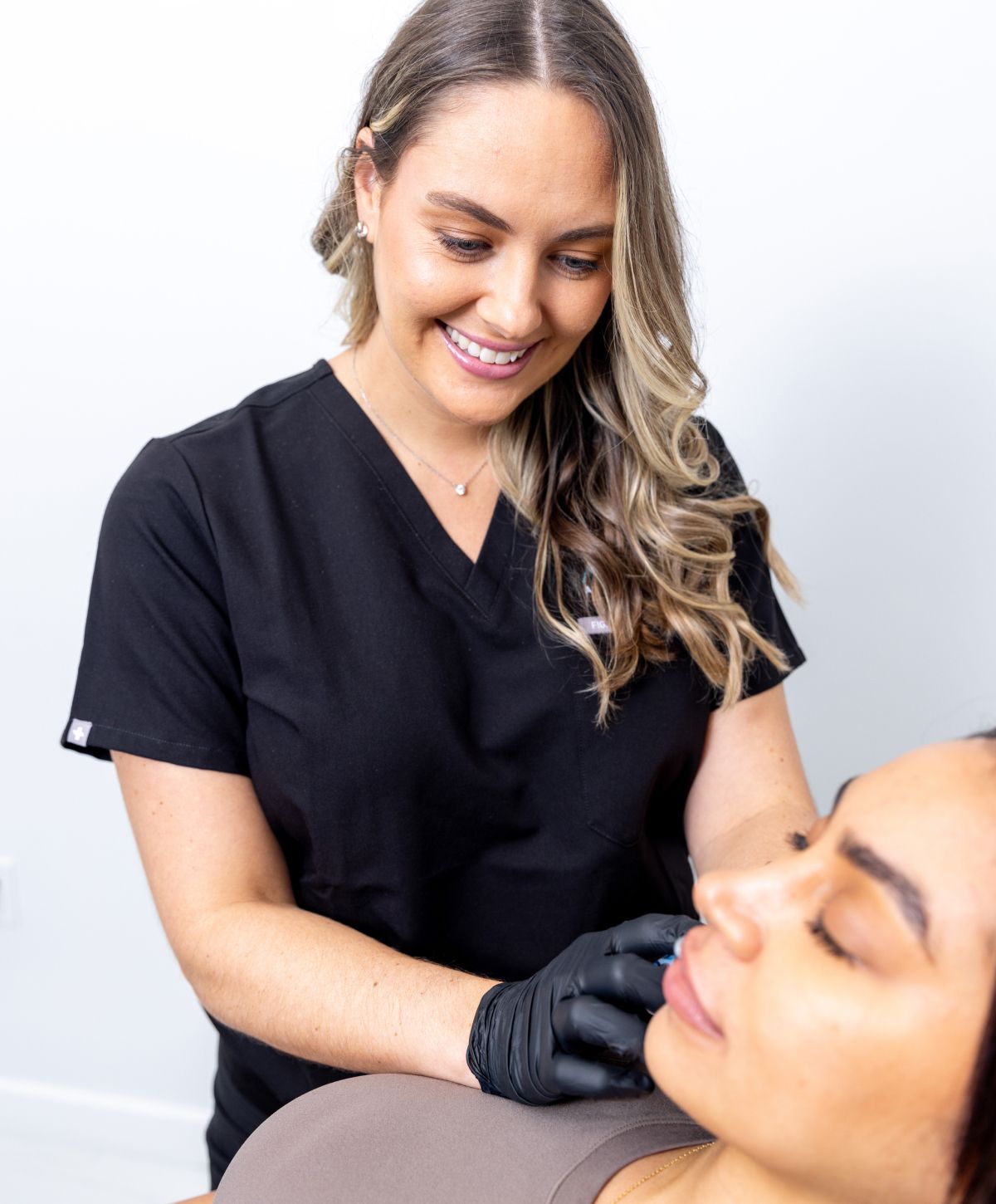 boca raton med spa practitioner administering radiesse treatment to a patient model's face.