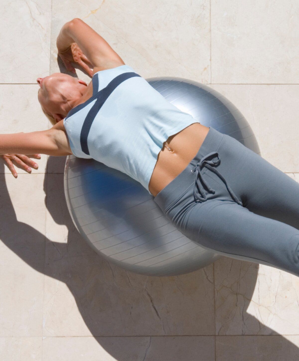 cold and flu iv therapy patient model exercising on a balance ball.