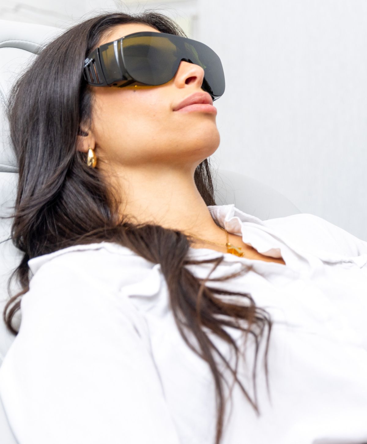 Evoke patient model relaxing with protective goggles in clinic boynton beach