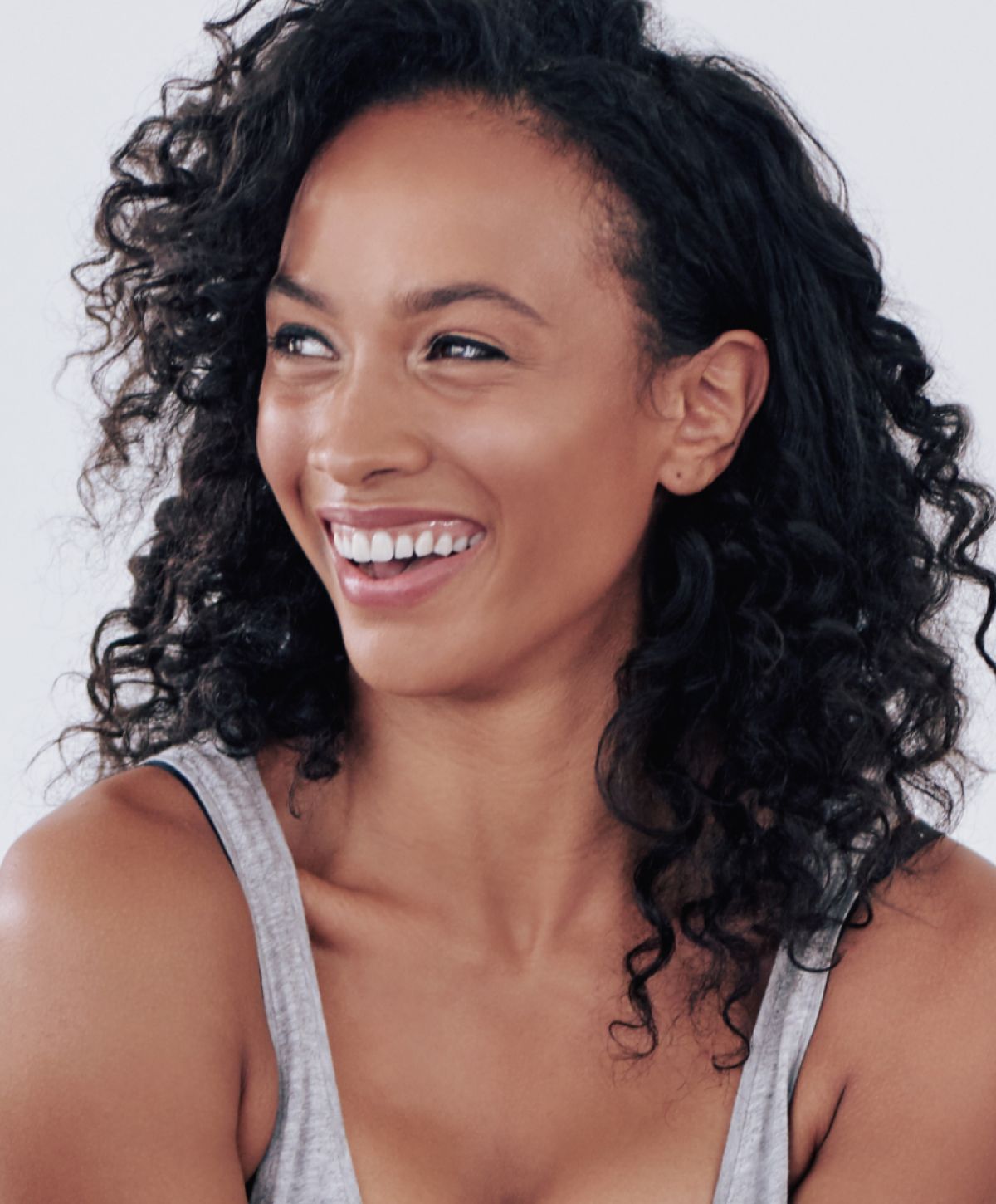 ipl photofacial smiling with curly hair and joyful expression.