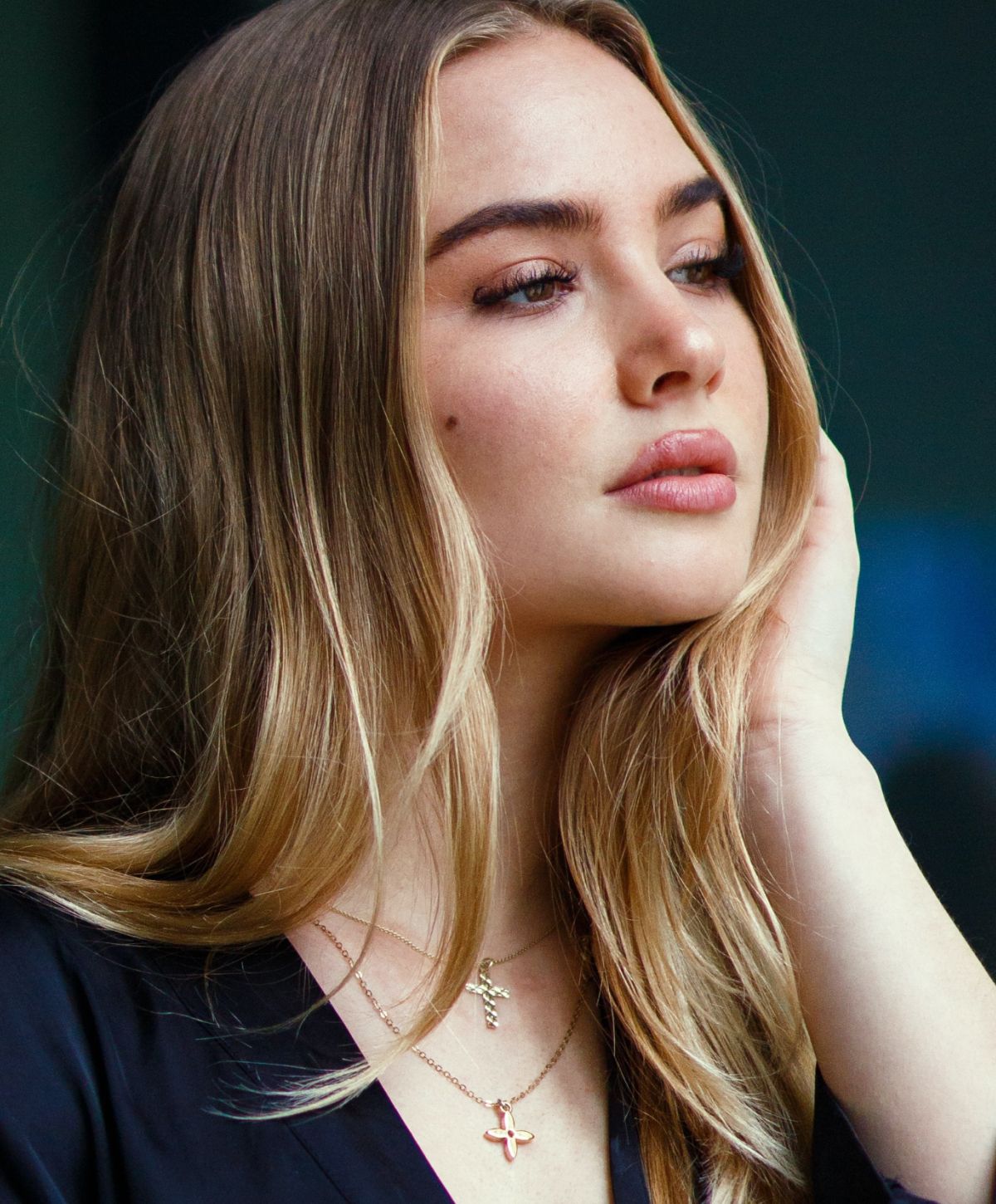 neogen plasma patient model with long hair and layered necklaces.