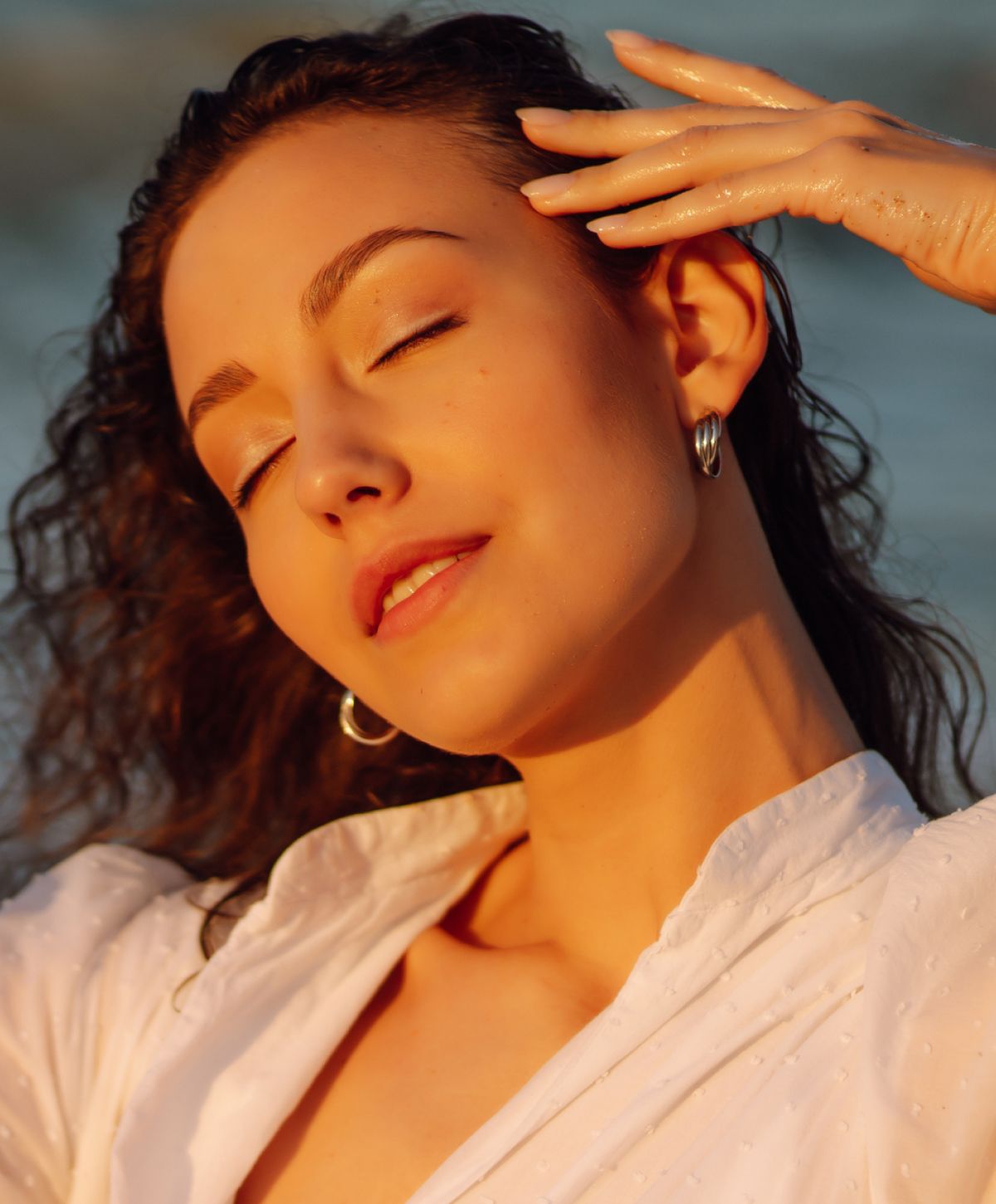 neogen plasma resurfacing patient model with curly hair enjoying warm sunlight.