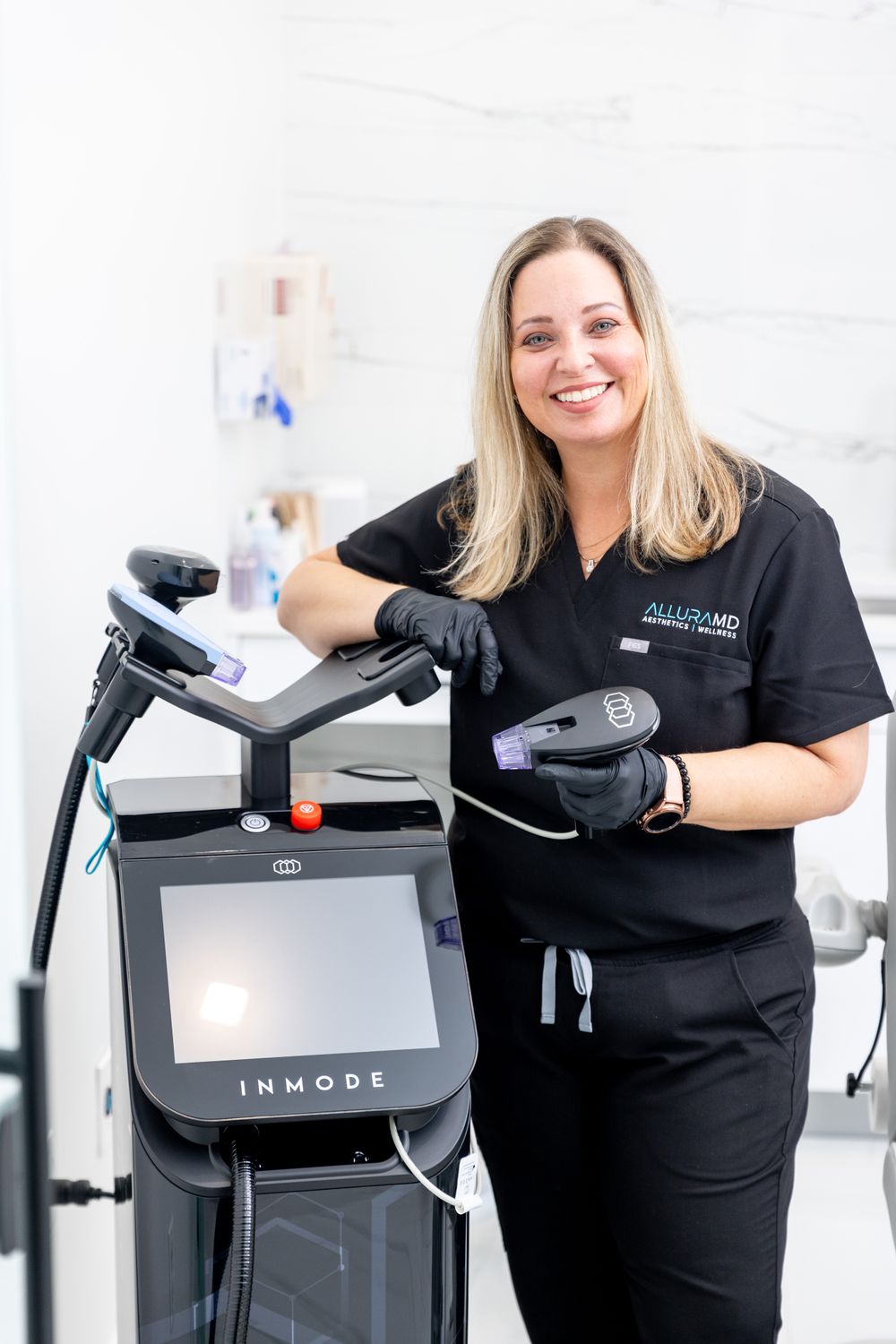 med spa staff with morpheus8 rf microneedling treatment equipment.