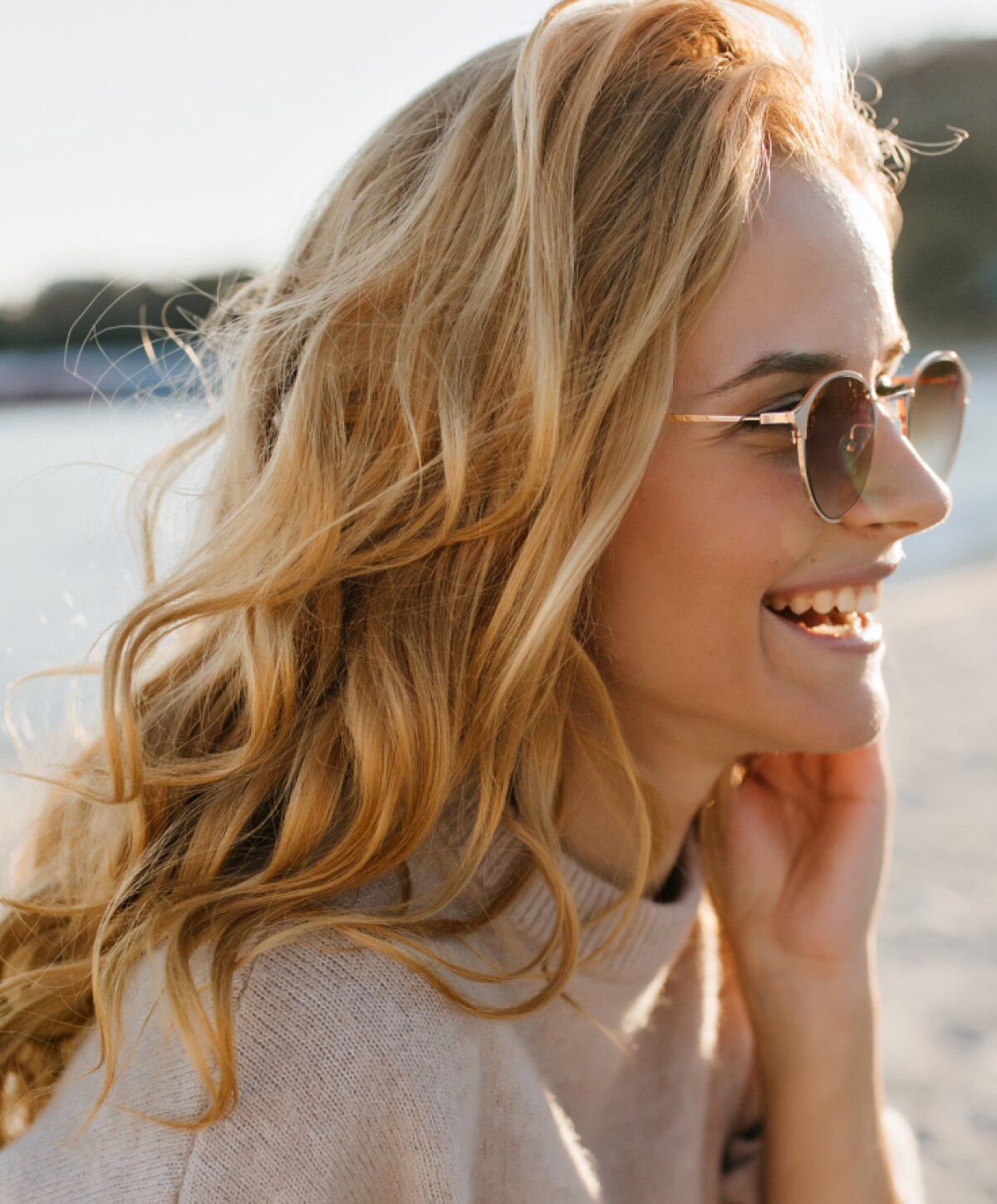 blonde boynton beach co2 laser skin resurfacing smiling in a beige sweater and sunglasses