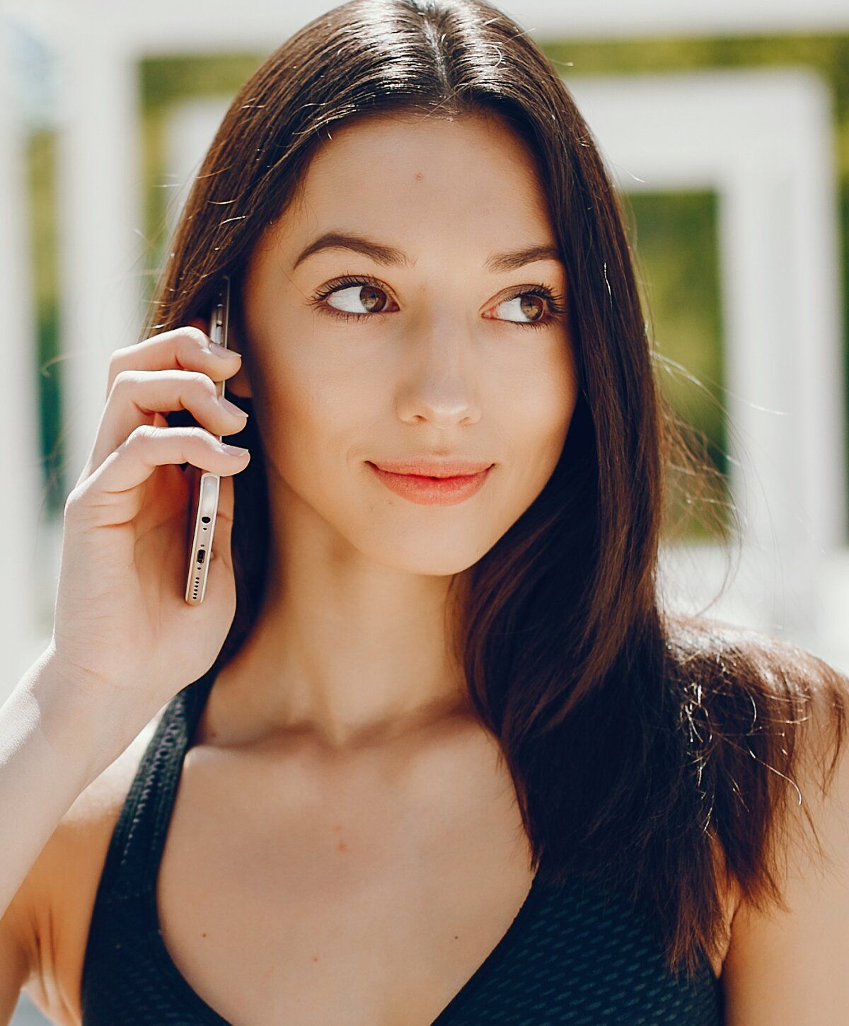 microneedling patient model talking on the phone outdoors.