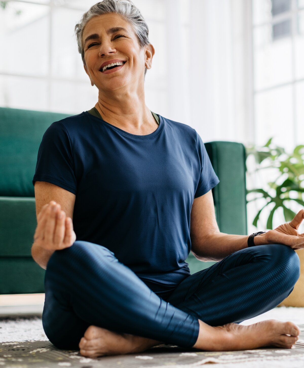 hormone replacement therapy patient model meditating in front of her couch