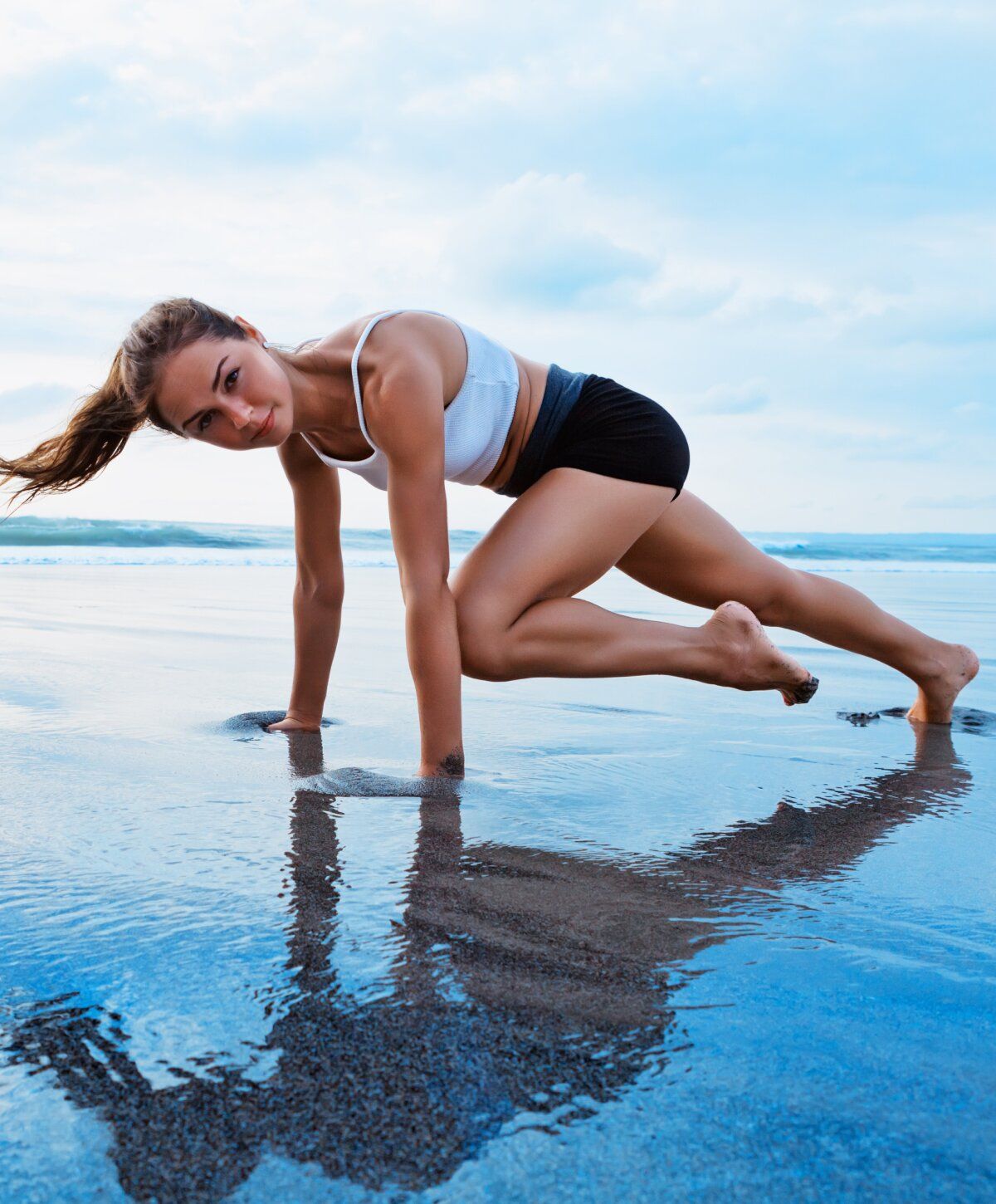 performance iv therapy patient model exercising on beach with ocean backdrop.