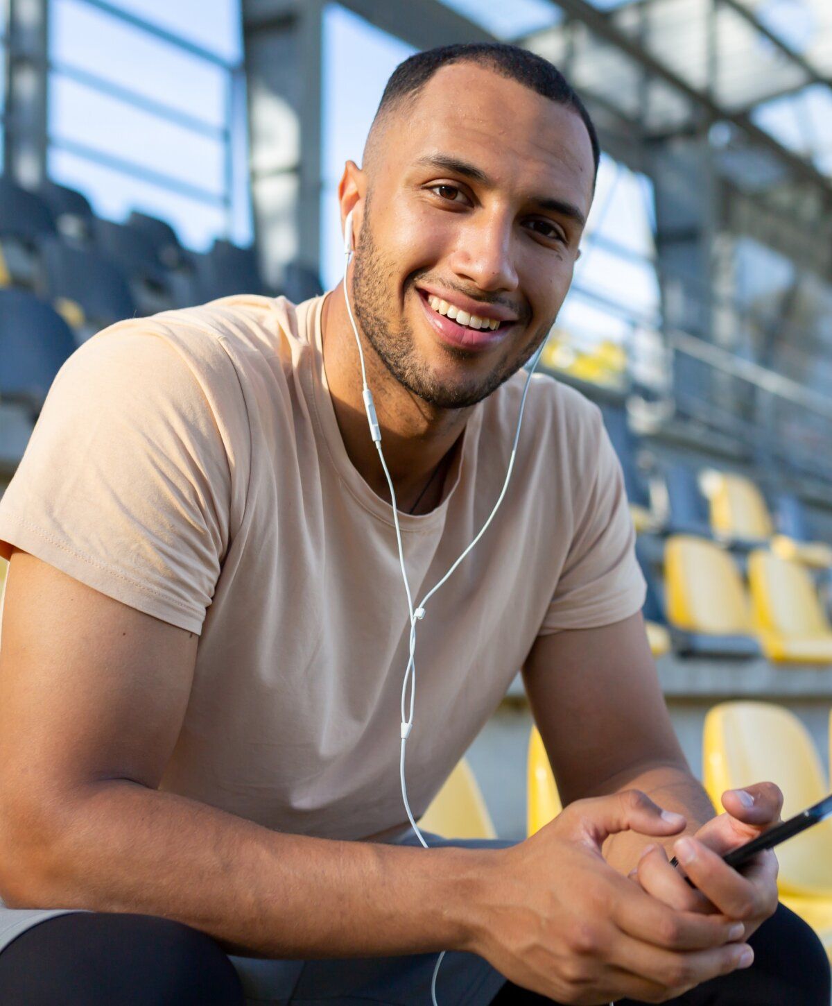 bpc 157 peptide therapy patient model sitting in stadium, listening to music.