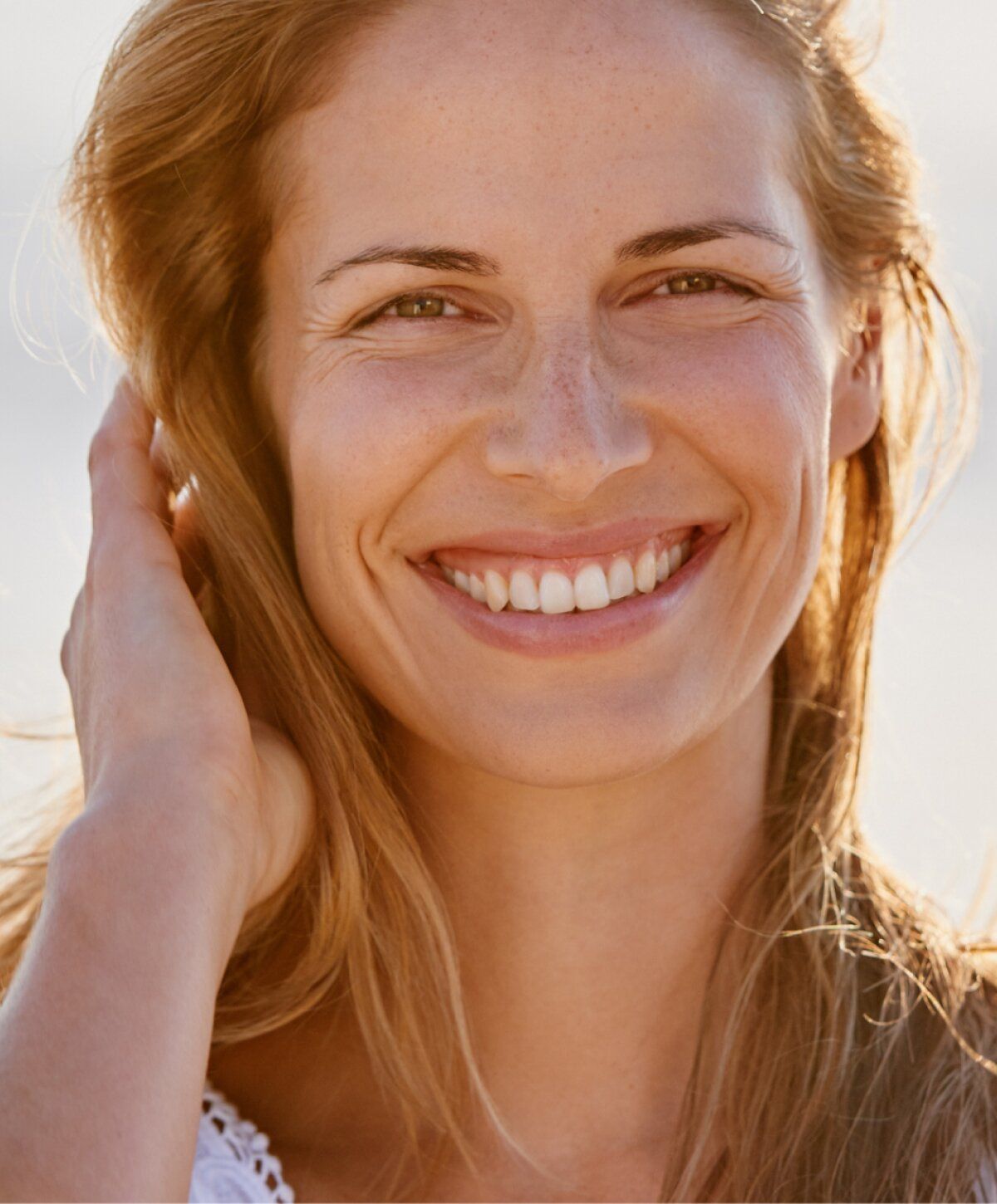 boynton beach wrinkle treatment patient model smiling with the sun behind her