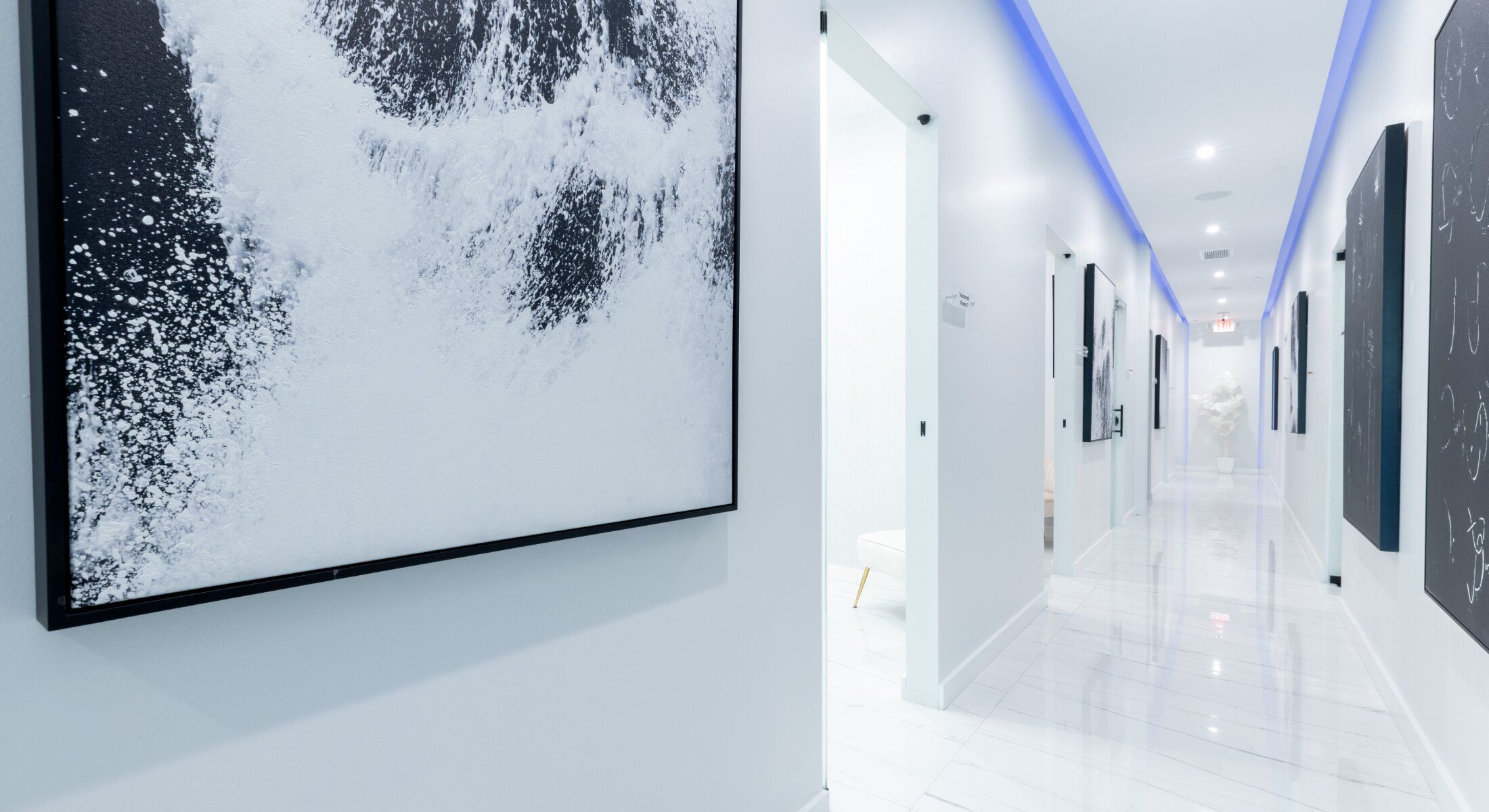 Modern hallway with artwork and ambient lighting.