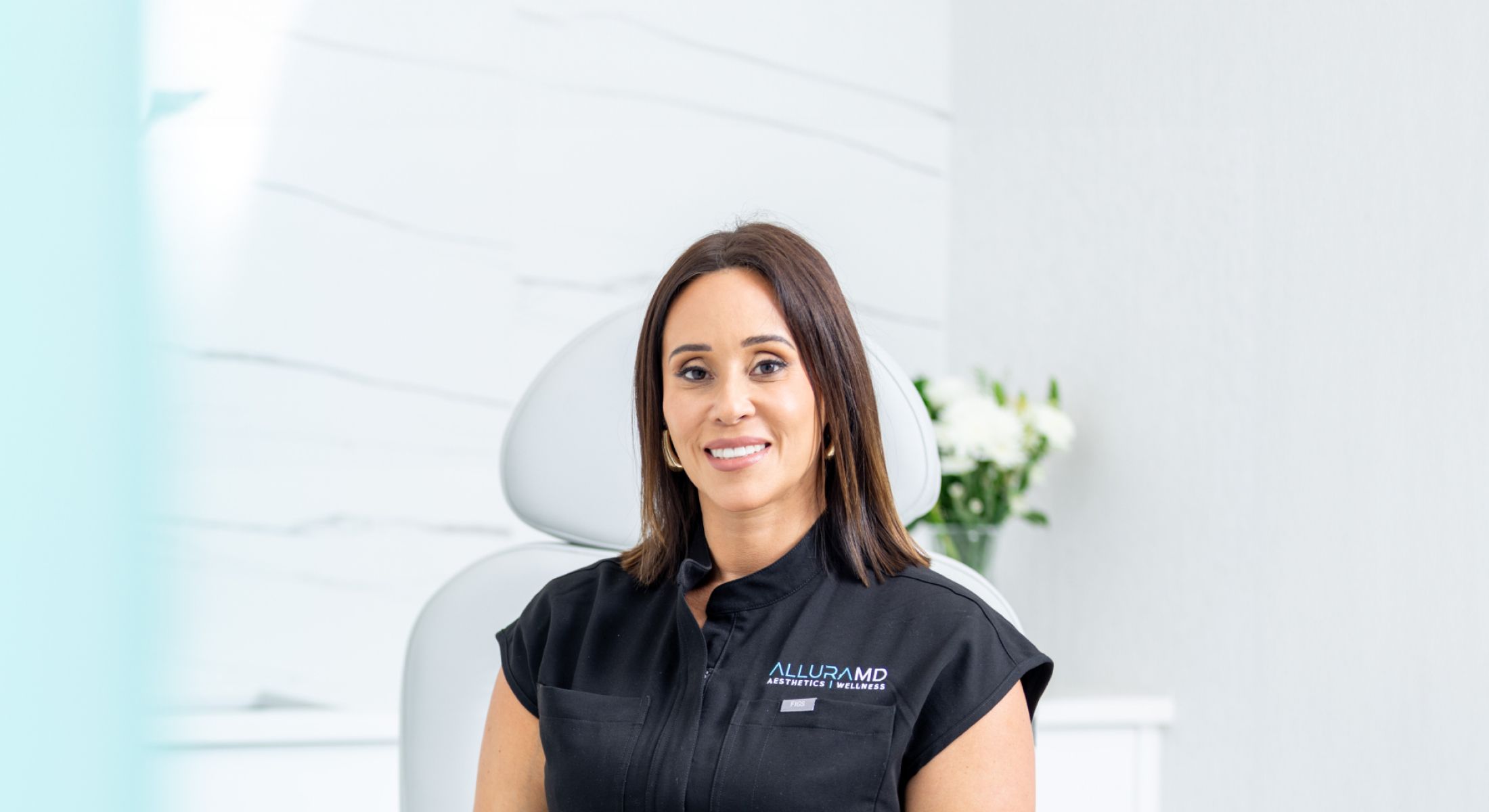Female doctor smiling in a medical office.