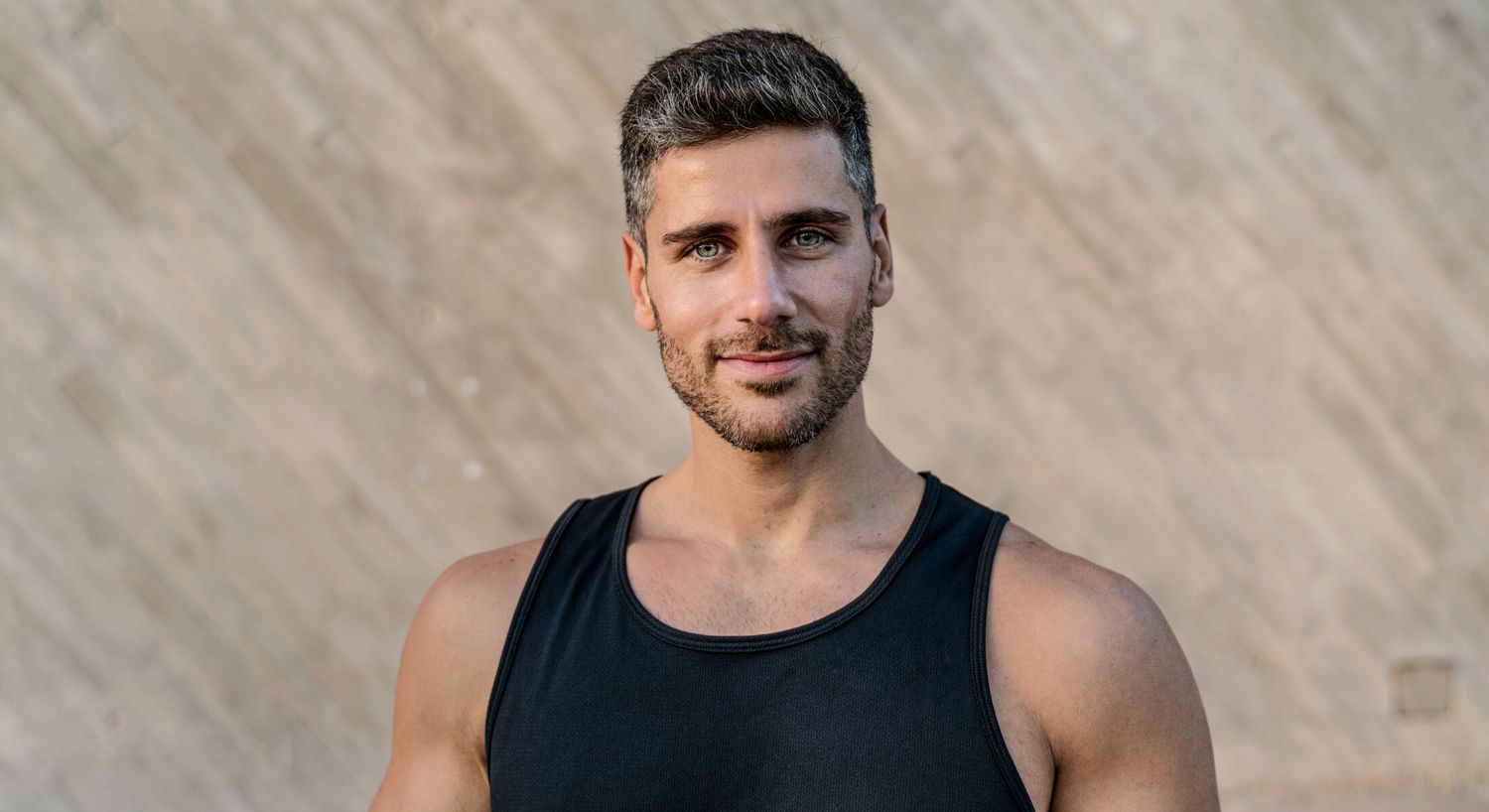 hair restoration with Growth Factors patient model with a beard in a black tank top