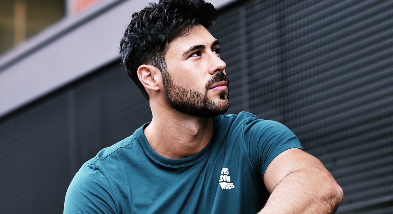 PRP Hair Restoration patient model sitting outside in a blue t shirt