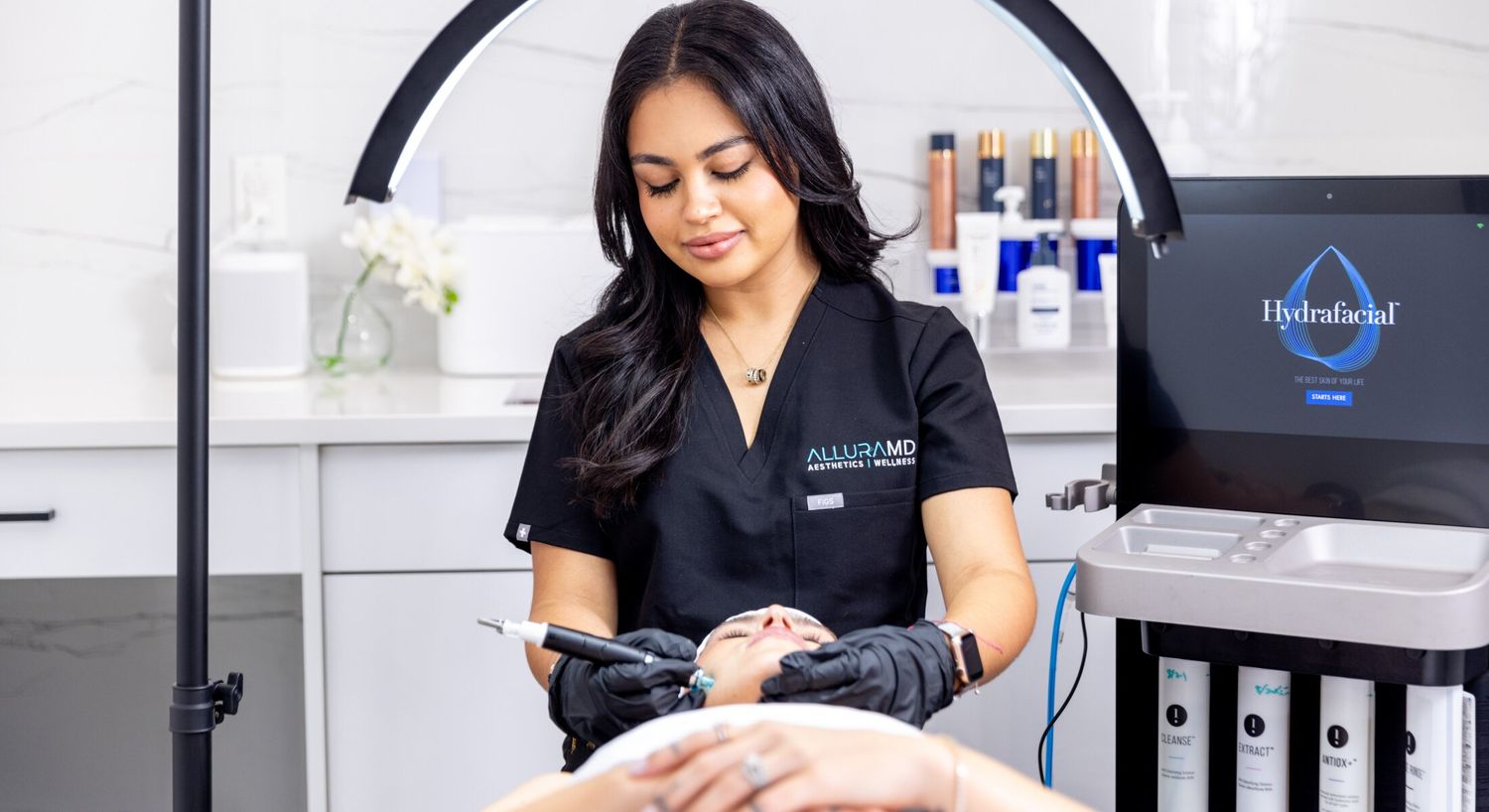 HydraFacial patient model receiving treatment in a med spa