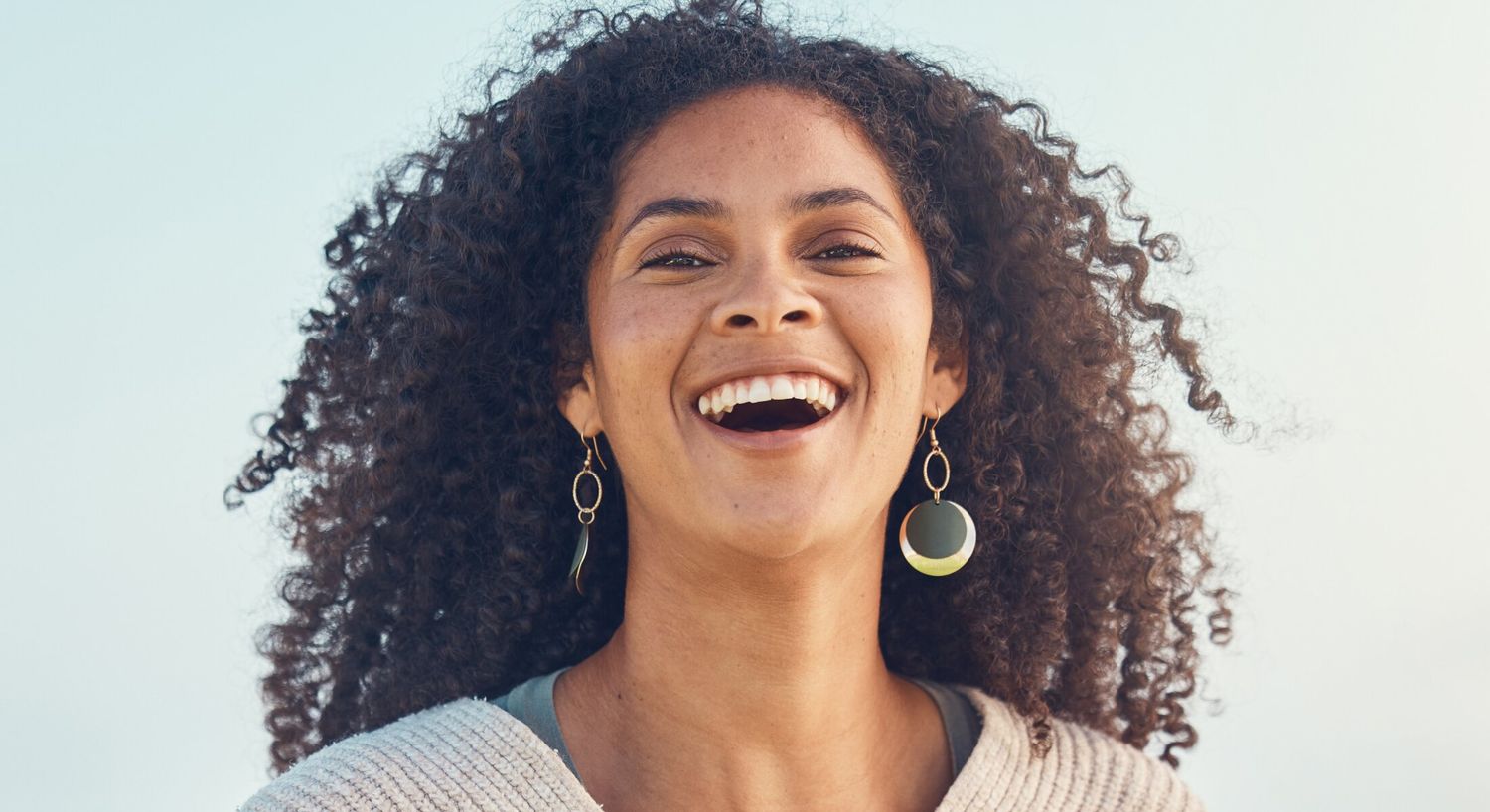 prp treatments patient model laughing with gold earrings