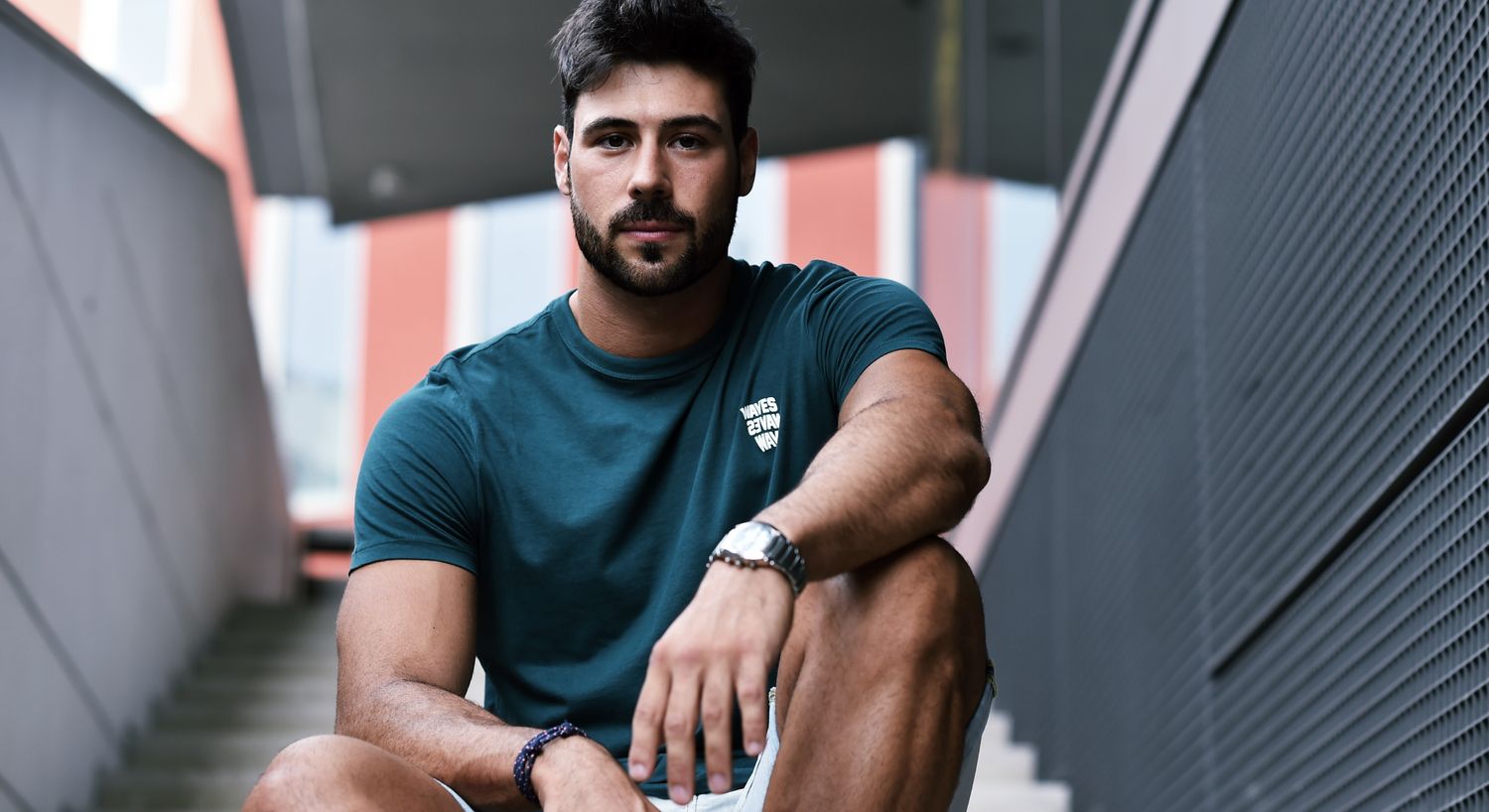 IV Nutrient Therapy patient model with a beard sitting on the stairs