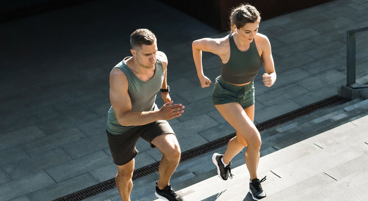 Gonadorelin peptide therapy patient model running up a flight of stairs in athletic wear with his partner