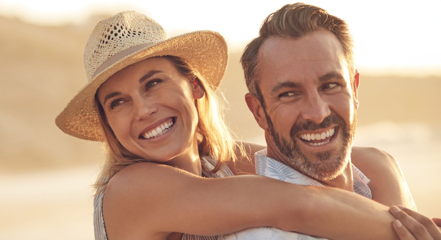 Myers Cocktail IV therapy patient model couple hugging and smiling outside in the sun